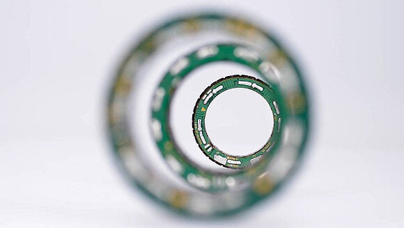 Unmanned vehicles with trucks and vans in the background