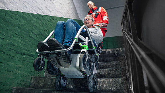 Unmanned vehicles with trucks and vans in the background