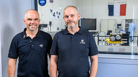 Unmanned vehicles with trucks and vans in the background