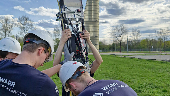 Unmanned vehicles with trucks and vans in the background